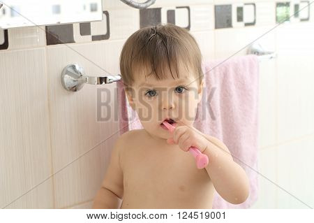 Kid Cleaning Teeth In Bathroom