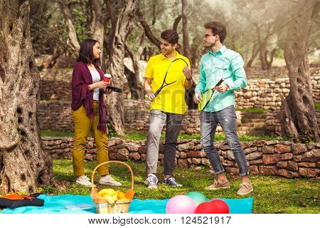 Three young people playing speedminton - badminton