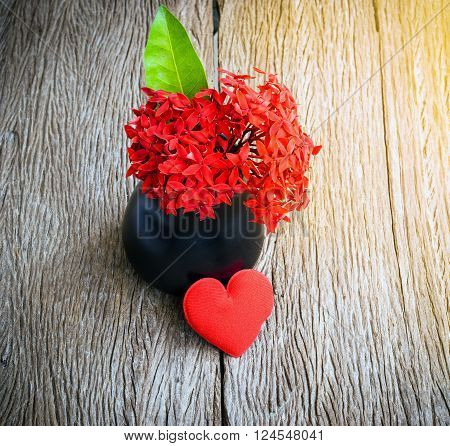 Red heart and red flower on old wooden for valentines day background.