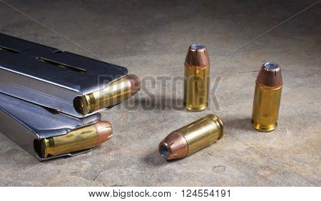 Cartridges for a semi automatic handgun loaded with hollow point bullets