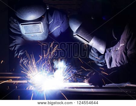 Welding and bright sparks. Concept and idea of hard job