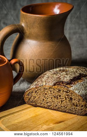 Still life with homemade bread and pottery close up.