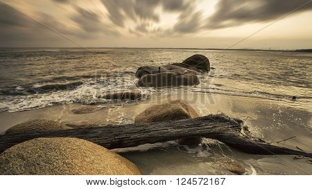 View of a rocky coast during sunset. Long exposure shot