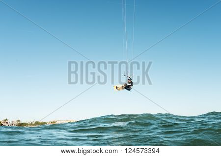 Surfer Jumping In Front Of The Beach