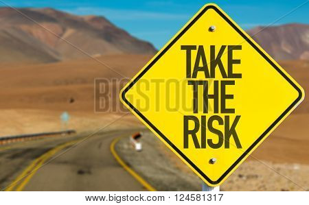 Take The Risk sign on desert road