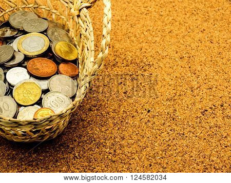 International old coin in the basket on cork board selective focus