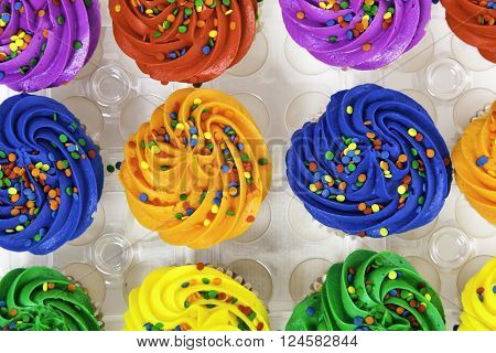 A Grou Pf Colorful Cupcakes On A White Background