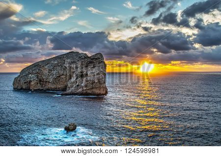 orange sunset over Isola Piana in Sardinia