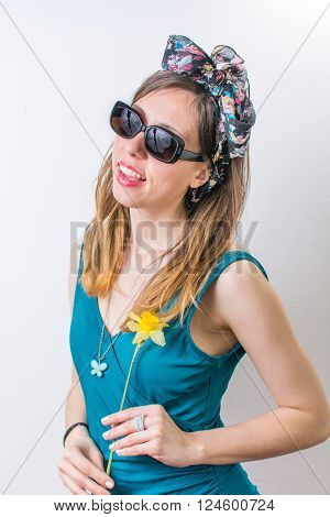 Young Woman In Bathing Suit Holding A Flower