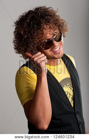 Thumbup cheerful young man with beautiful curls