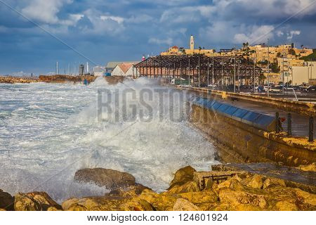 New Quay in the Old Jaffa, Israel. Whole gale in the Mediterranean Sea. Huge foamy waves fight about the coast