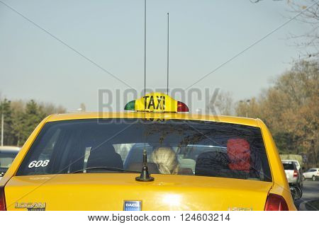 BUCHAREST ROMANIA - NOV 28 2008: Yellow taxi cab with huge antennas wating in traffic jam on the Bucharest boulevards