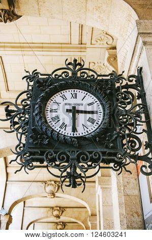 PARIS FRANCE - AUGUST 18 2014: Henry Lepaute street clock ornated with steel flowers and decorations on the streets of Paris France