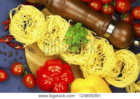 dried pasta and selection on dark blue  background