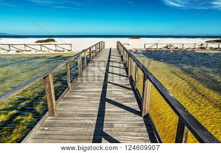 wooden boardwalk to the beach in Sardinia