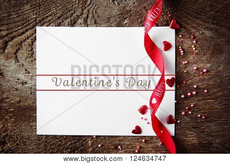 Blank present Valentine card on wooden background