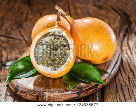 Granadilla fruits on the wooden table.