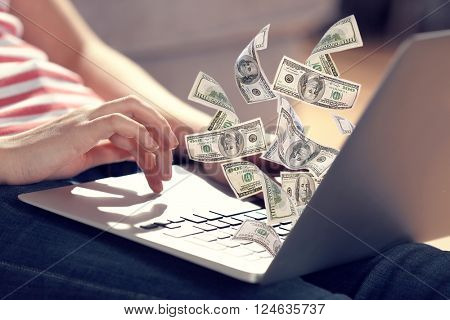 Financial concept. Make money on the Internet. Woman sitting on the floor and working with a laptop