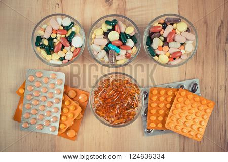 Vintage photo, Colorful medical pills and capsules for therapy and blisters of tablets or supplements, concept of treatment and health care
