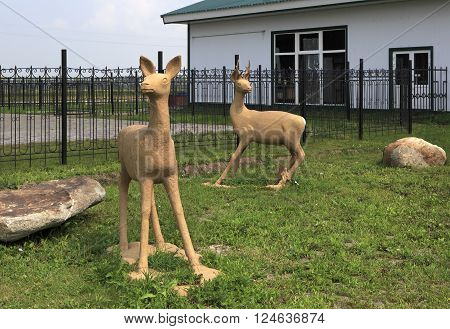 Novotyryshkino, Russia - July 31, 2013: Sculptures of deer on the lawn. Tourist Complex Siberian Podvorye.