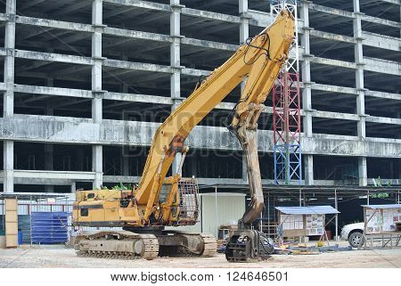 SELANGOR, MALAYSIA - MARCH 12, 2015: Sheet pile cofferdam driven machine at the construction site. This machine drove the sheet pile to the earth using vibrated hydraulic arm. Workers control.