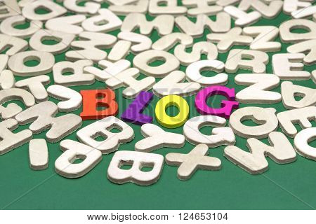 Blog Colored Sign Among Different Uncolored Letters On Green Background Top View Close Up