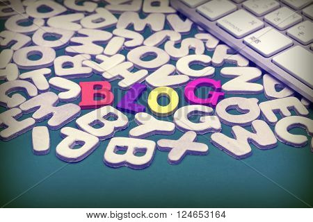Blog Colored Sign Among Different Uncolored Letters On Green Background Top View Close Up
