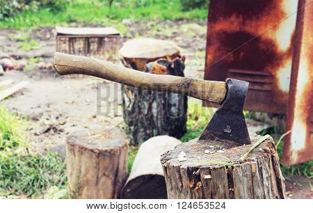 An axe on a stump in the garden