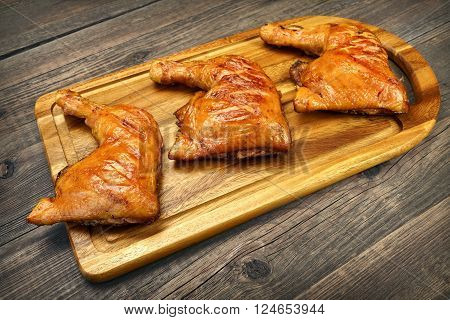 Three Grilled Bbq Chicken Leg Quarter On Wood Board