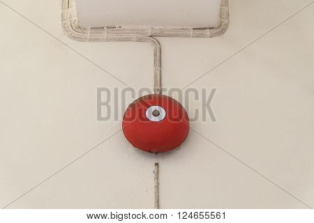 red fire alarm box for warning security system mounted on wall