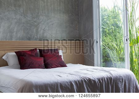 bedroom interior design modern style with white mattress and red pillow and wooden headboard