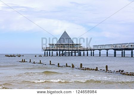Heringsdorf Usedom Germany - June 27 2012: Famous pier with restaurant building at its end. A tourist hotspot at the beach / baltic sea.