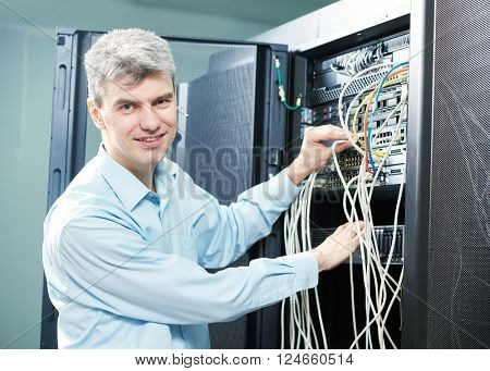 network engineer administrator in server room 
