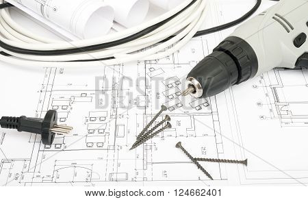 Architecture plan and rolls of blueprints with cabel and electric screwdriver. Building concept