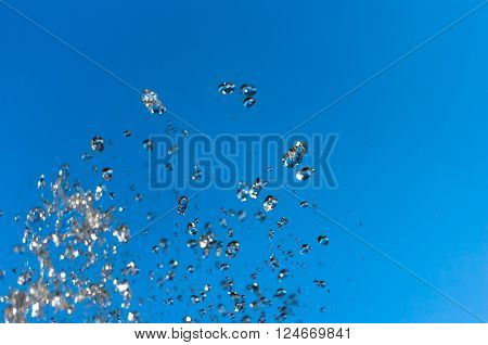 Water fountain on a background of blue sky