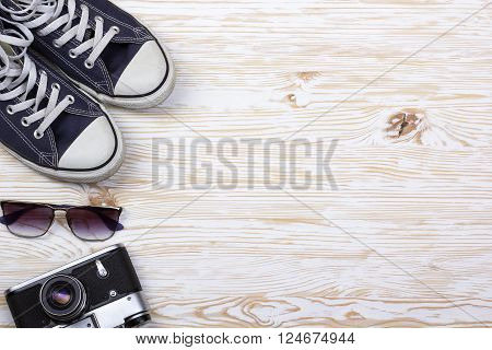 still life with sneakers analogue camera and sungalsses