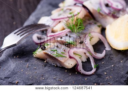Sliced Herring On A Black Slate Plate