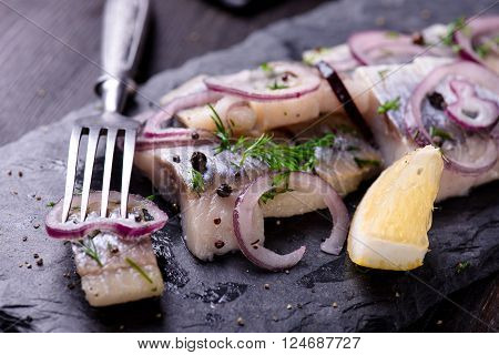 Sliced Herring On A Black Slate Plate