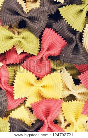 raw bow-knot pasta of different color, background