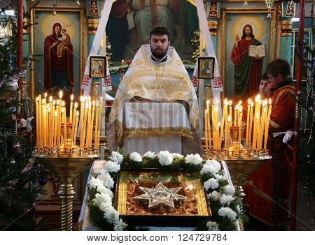 VOYUTYN UKRAINE - JANUARY 08: Orthodox priest during Christmas service in Voyutyn on January 08 2009.