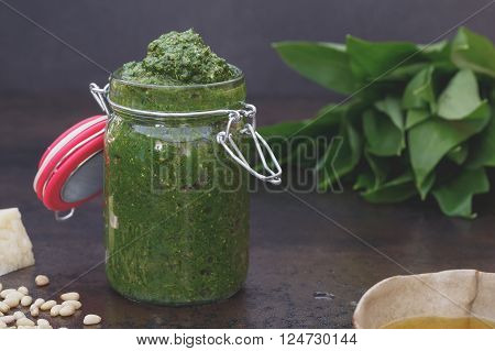 Ramson pesto in jar. Ramson pesto,  fresh ramson and ingredients. Macro, selective focus, vintage toned image, blank space