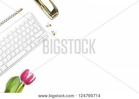 Office desk and woman objects on white table. Flat lay. Tulip gold stapler pencil. Table view. Still life of fashion