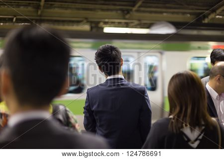 Passengers traveling by Tokyo metro. Business people commuting to work by public transport in rush hour. Shallow depth of field photo.
** Note: Soft Focus at 100%, best at smaller sizes