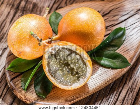 Granadilla fruits on the wooden table.