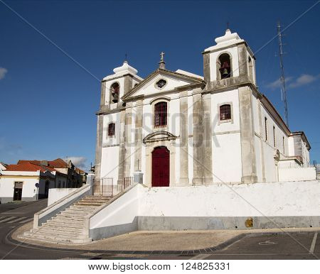Old Sao Pedro Church facade and staircase in Palmela under a blue dark sky. Setubal Portugal.