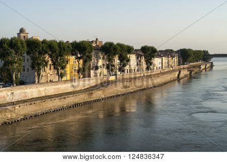 Arles (Bouches-du-Rhone Provence-Alpes-Cote-d'Azur France): cityscape along the river at evenng