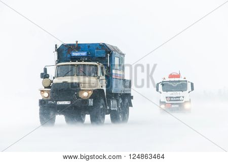 NOVYY URENGOY RUSSIA - MARCH 20 2016: Truck Ural 4320 at the interurban freeway during a heavy northern blizzard.