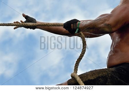 Tug of War,Muscular man extends a rope