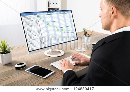 Businessman Working On Gantt Chart At Office
