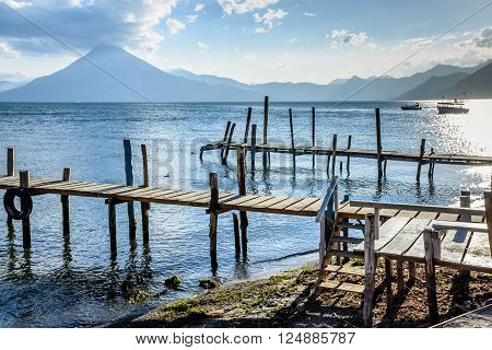 Evening light on jetties on Lake Atitlan with San Pedro volcano behind in Guatemala